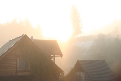 Photo of Beautiful view of sunrise over wooden houses