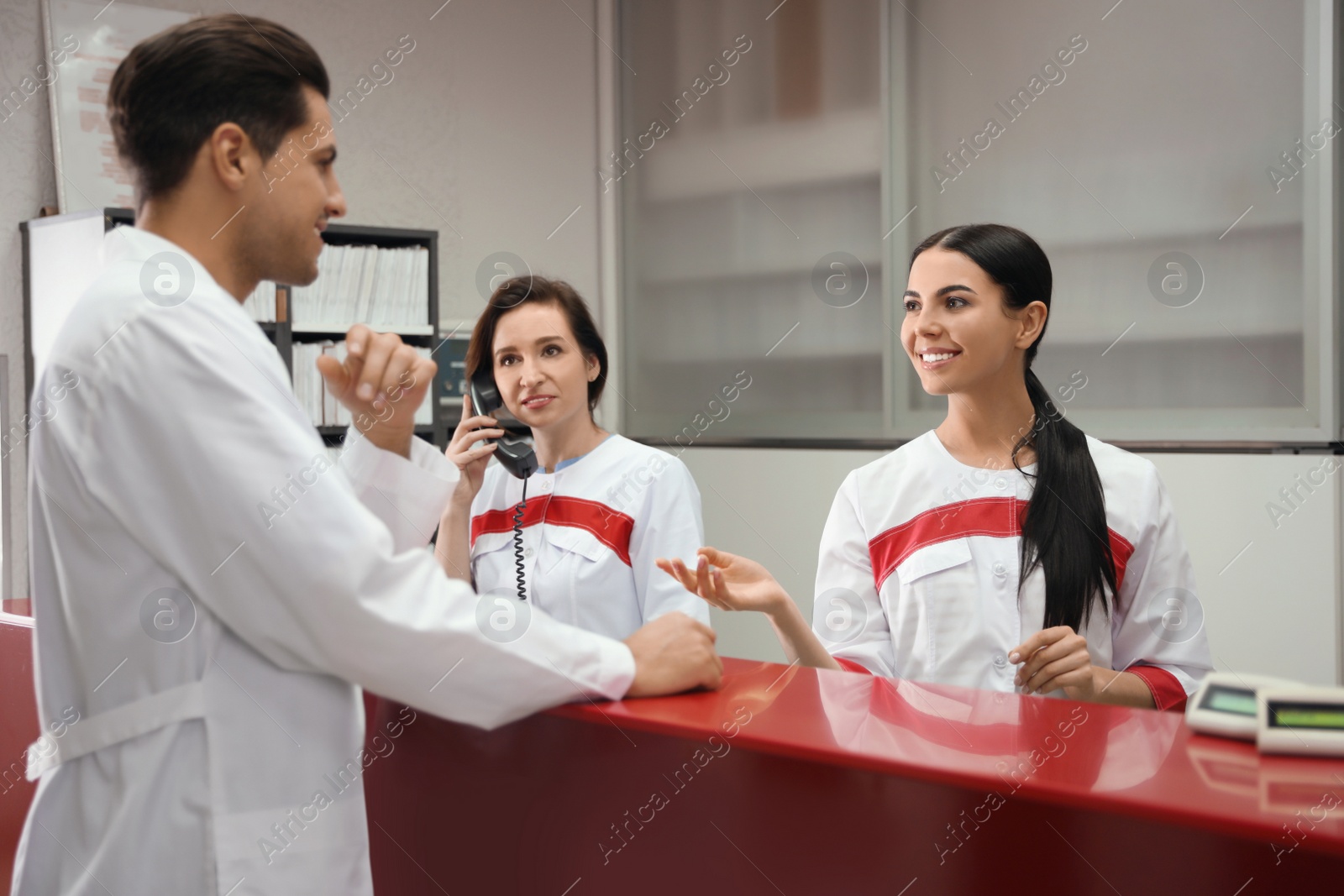 Photo of Reception of modern surgery clinic with working staff