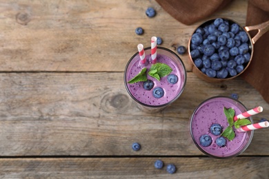 Photo of Flat lay composition with delicious blueberry smoothie on wooden background. Space for text