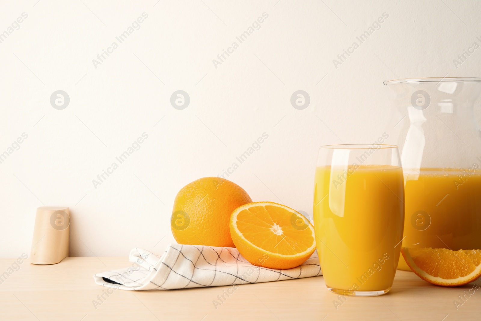 Photo of Orange juice and fresh fruits on wooden table. Space for text