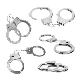 Image of Set with classic chain handcuffs on white background