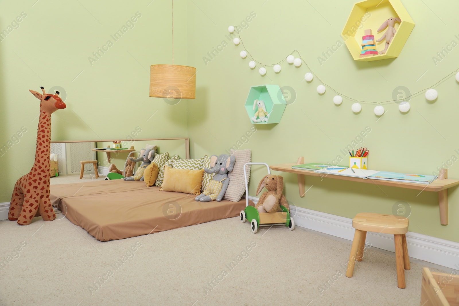 Photo of Montessori bedroom interior with floor bed and toys