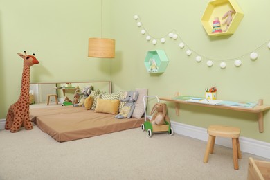 Montessori bedroom interior with floor bed and toys