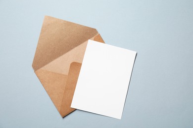 Photo of Letter envelope and card on grey background, top view. Space for text