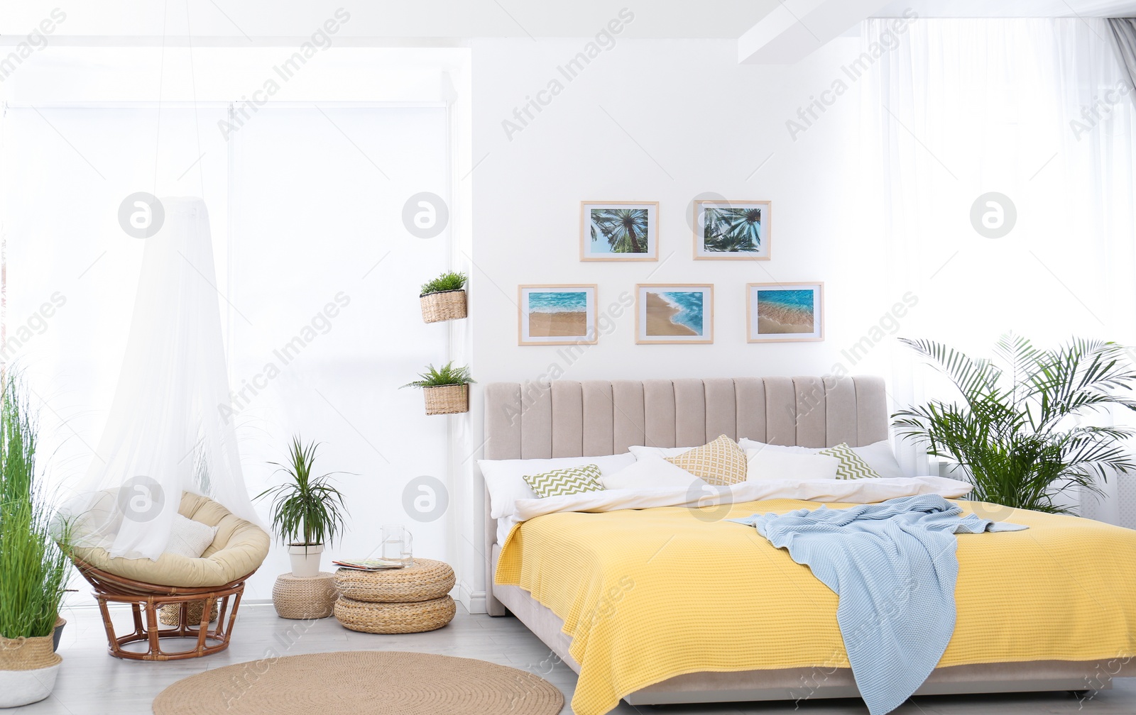 Photo of Stylish room interior with large comfortable bed and beautiful paintings