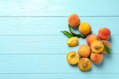 Photo of Fresh sweet peaches on wooden table, top view