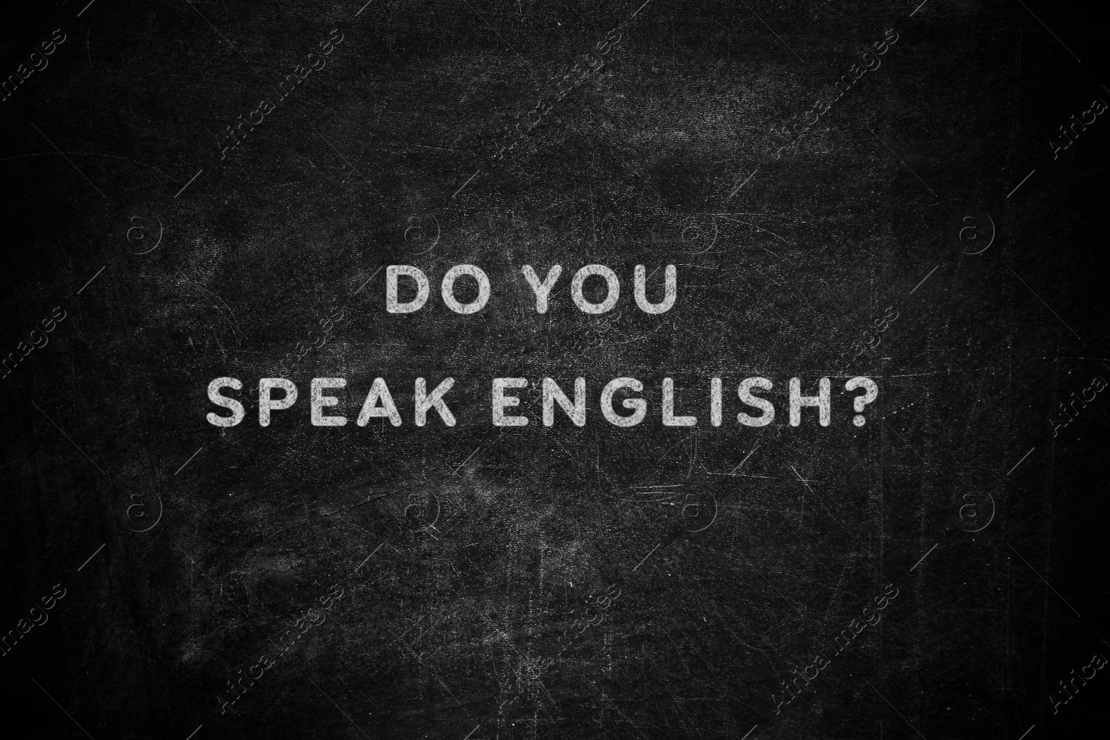 Image of Black chalkboard with text Do You Speak English