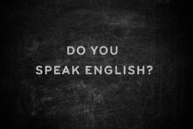 Image of Black chalkboard with text Do You Speak English