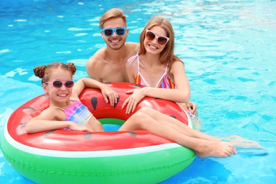 Happy family in pool on sunny day