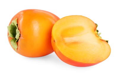 Photo of Whole and cut persimmon fruits isolated on white