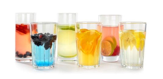 Photo of Glasses with tasty lemonades on white background