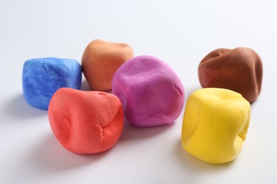 Different color play dough on white background