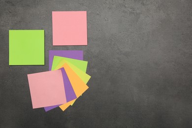 Colorful stickers on grey stone table, flat lay. Space for text