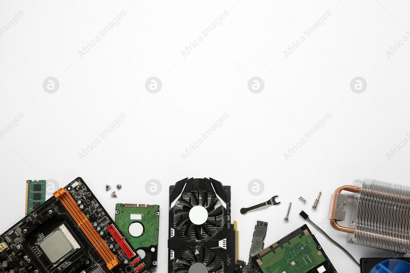 Photo of Graphics card and other computer hardware on white background, flat lay. Space for text