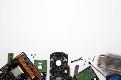 Photo of Graphics card and other computer hardware on white background, flat lay. Space for text