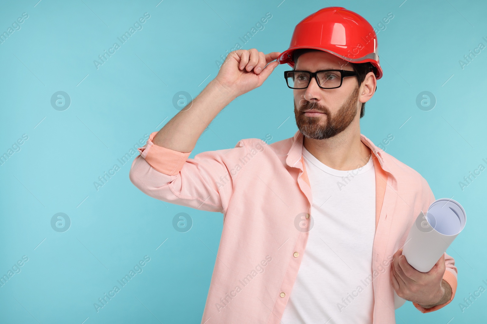 Photo of Architect in hard hat with draft on light blue background, space for text