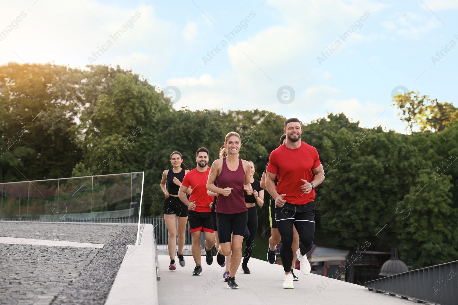 Photo of Group of people running outdoors. Active lifestyle