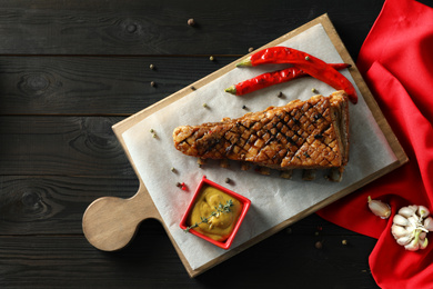 Photo of Delicious roasted ribs served on wooden table, flat lay