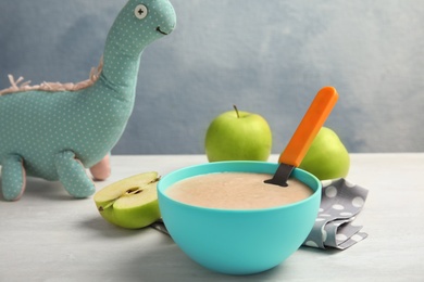 Photo of Bowl of healthy baby food on light table