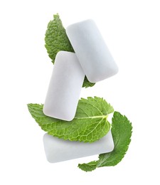 Image of Fresh mint leaves and chewing gum pads falling on white background