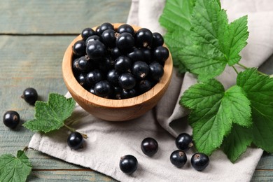 Ripe blackcurrants and leaves on wooden rustic table