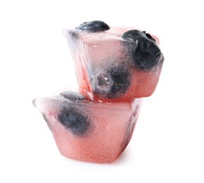 Ice cubes with berries on white background