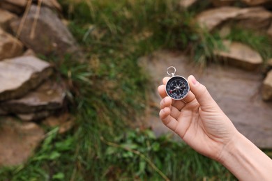 Photo of Woman using compass during journey outdoors, closeup. Space for text
