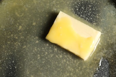 Photo of Melting butter in frying pan, top view