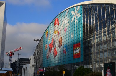 Photo of Paris, France - December 10, 2022: Beautiful cityscape with Lego Christmas advertising on building exterior