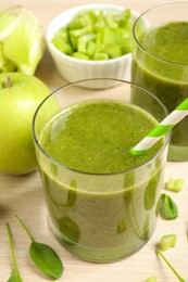 Photo of Delicious fresh green juice on wooden table, closeup