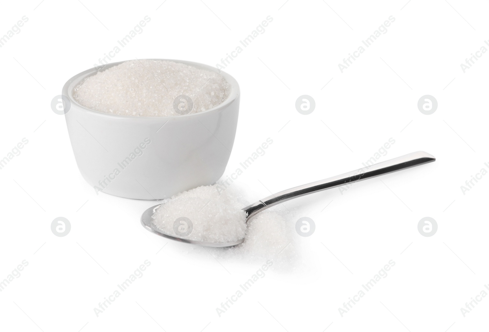 Photo of Bowl and spoon of granulated sugar on white background