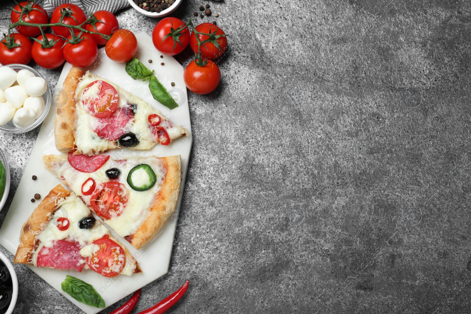 Photo of Flat lay composition with pieces of delicious pizza Diablo on dark background, space for text