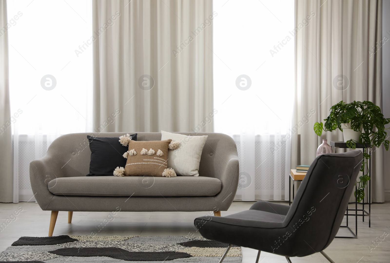 Photo of Modern living room interior with comfortable sofa and armchair