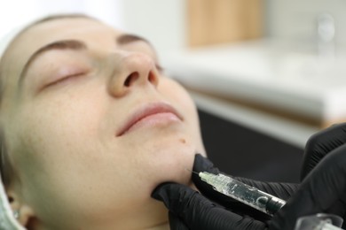 Photo of Cosmetologist giving facial injection to patient, closeup. Cosmetic surgery