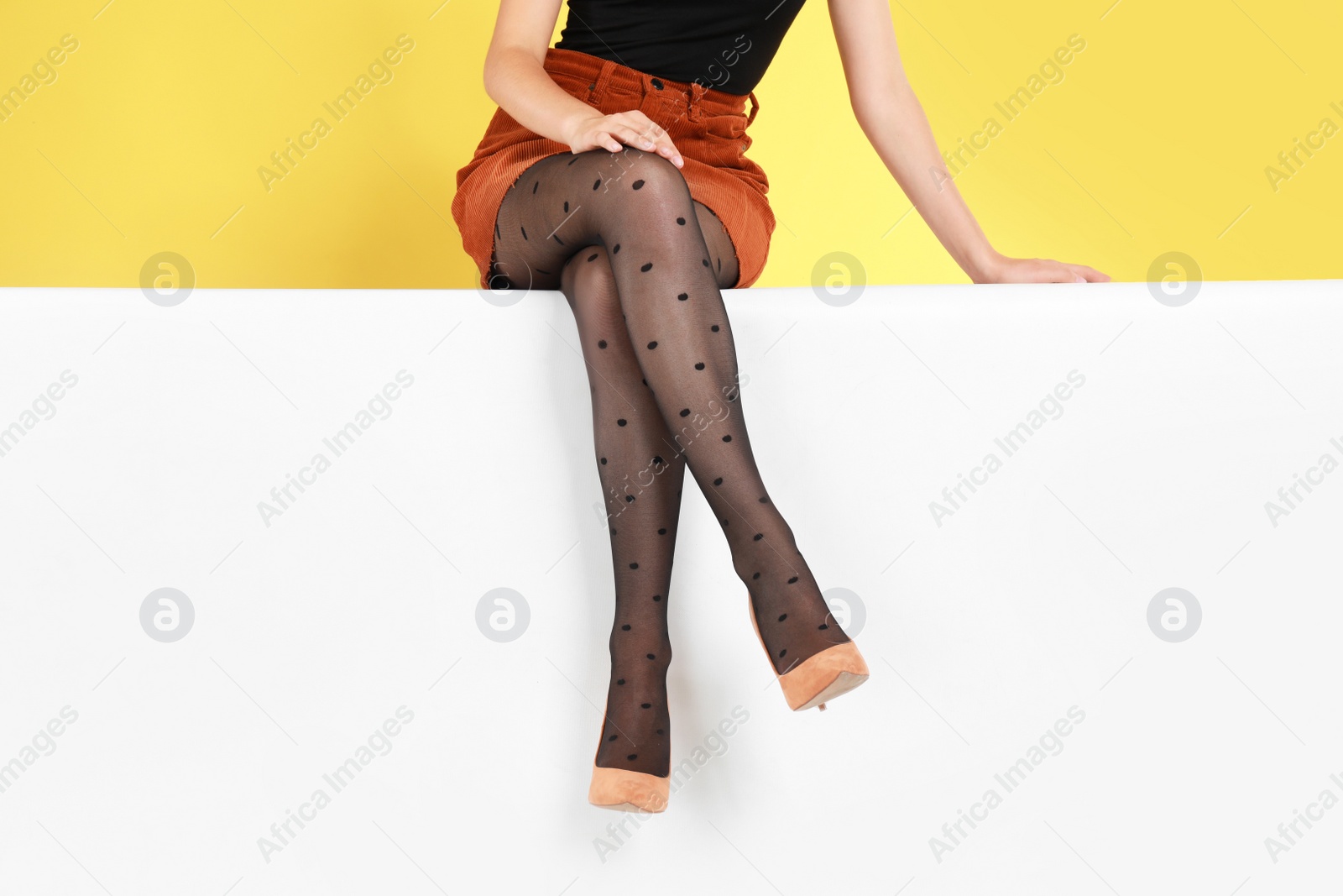 Photo of Woman wearing stylish shoes on color background, closeup