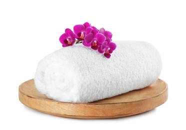 Photo of Tray with orchid and towel on white background. Spa treatment