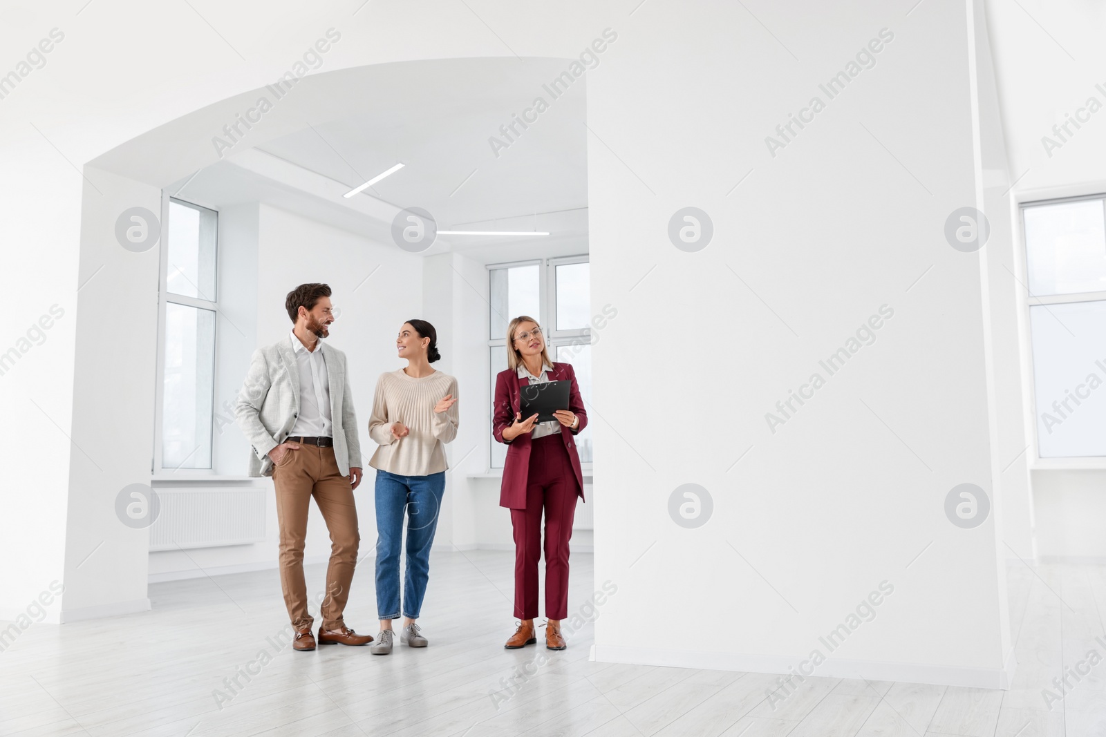 Photo of Real estate agent showing new apartment to couple