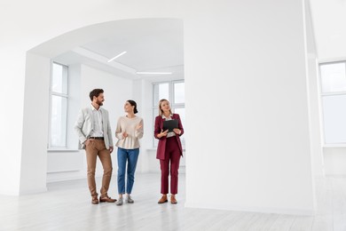 Real estate agent showing new apartment to couple