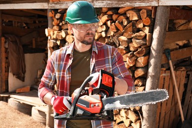 Man with modern saw on sunny day