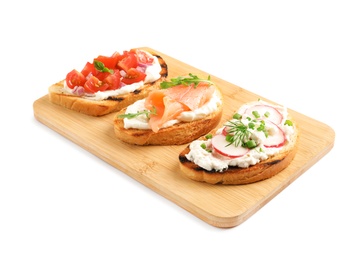 Board with different tasty bruschettas on white background