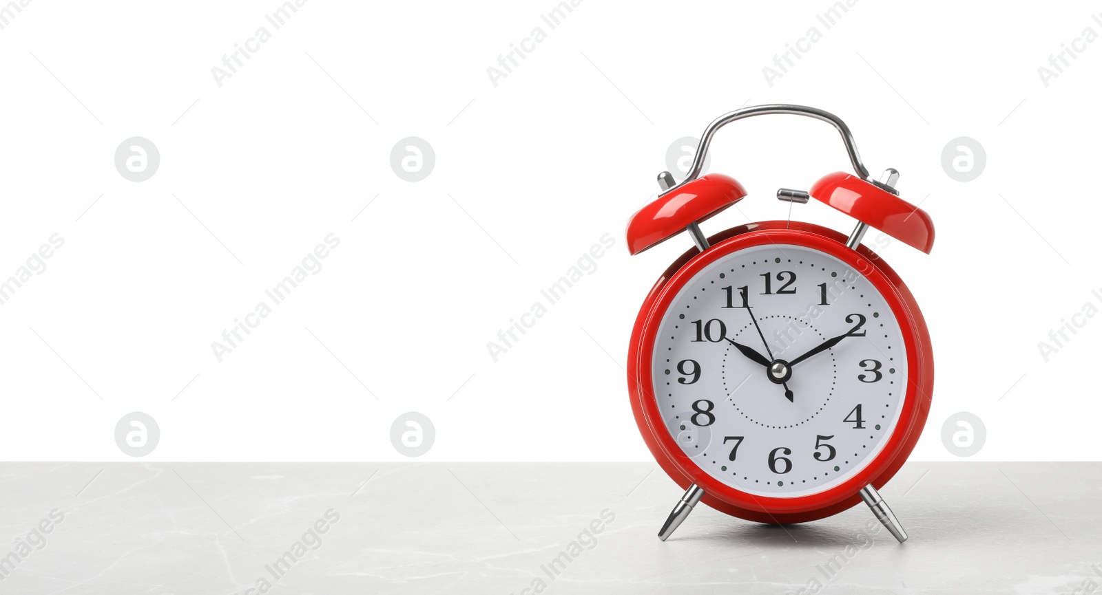 Photo of Alarm clock on table against white background. Time concept