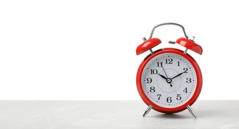 Photo of Alarm clock on table against white background. Time concept