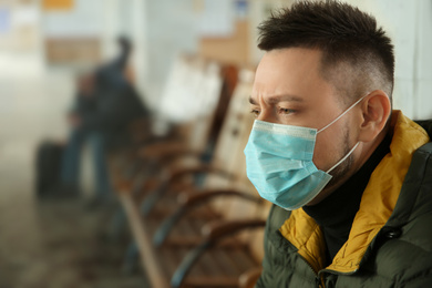 Man with disposable mask indoors. Virus protection