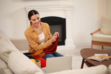 Photo of Teacher conducting online knitting course at home. Time for hobby