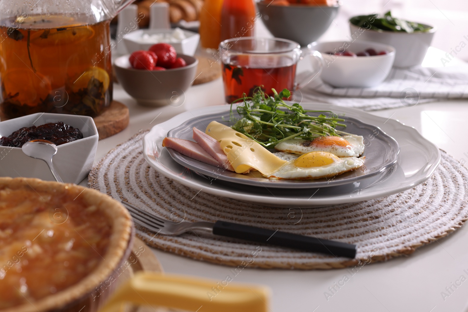 Photo of Fried eggs with sausage and cheese served on buffet table for brunch