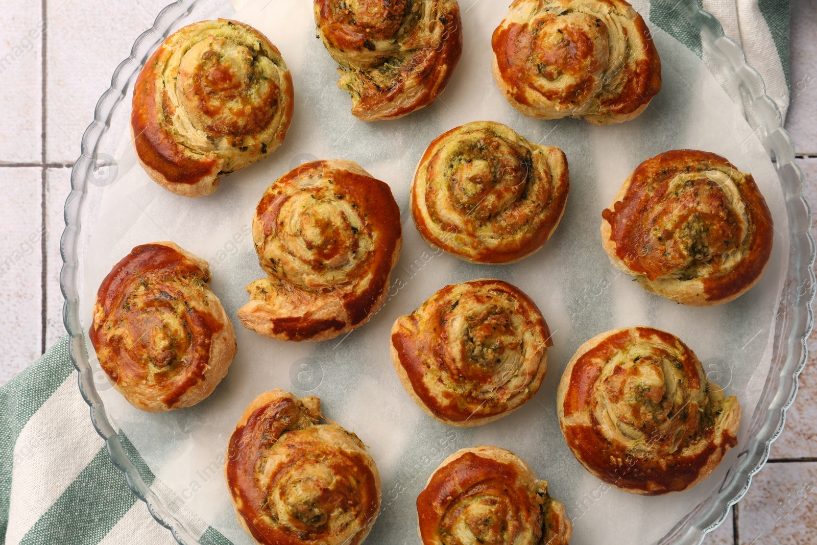 Photo of Fresh delicious puff pastry with tasty filling on white tiled surface, top view