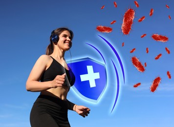 Young woman listening to music while running outdoors in morning, low angle view. Strong immunity - shield against viruses