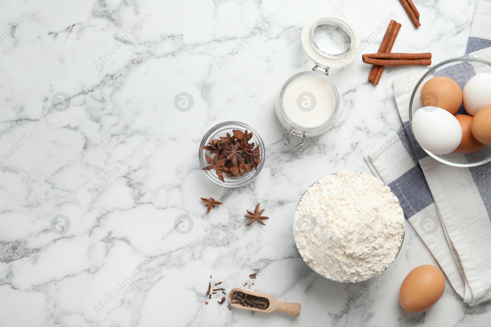 Photo of Composition with flour, eggs and spices on light background, top view