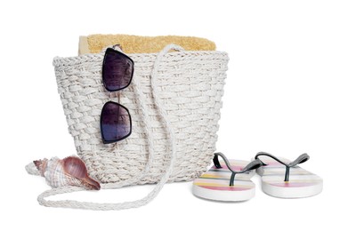 Photo of Beach bag, sunglasses, towel, flip flops and sea shell isolated on white