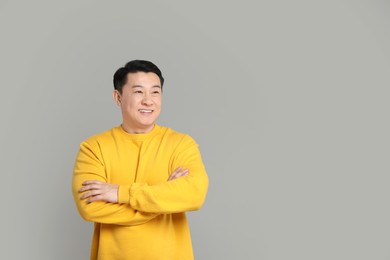 Photo of Portrait of happy man on grey background. Space for text